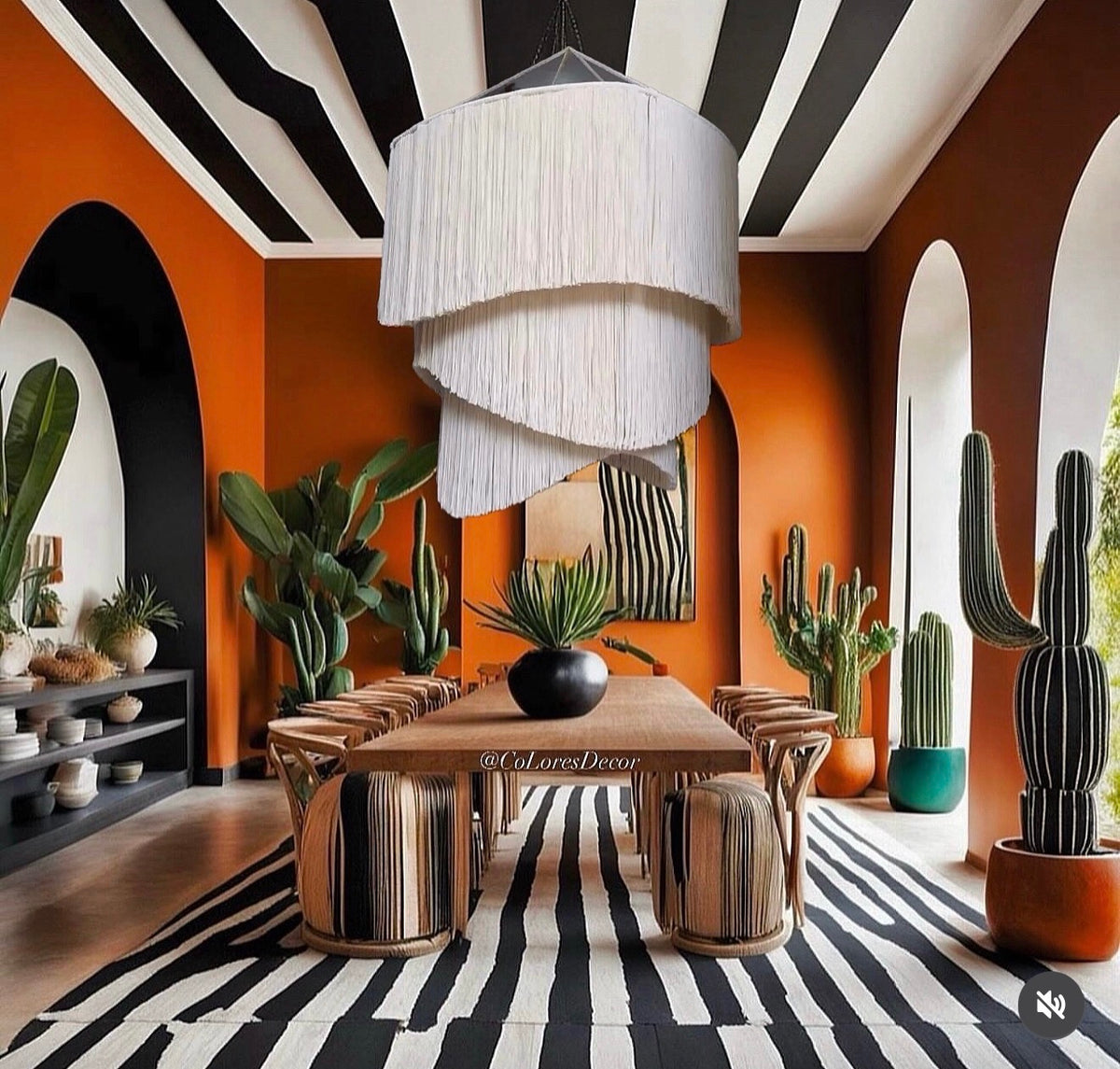 Dining room rendering with a white tiered tassel chandelier, wooden table, orange walls, and striped rug.
